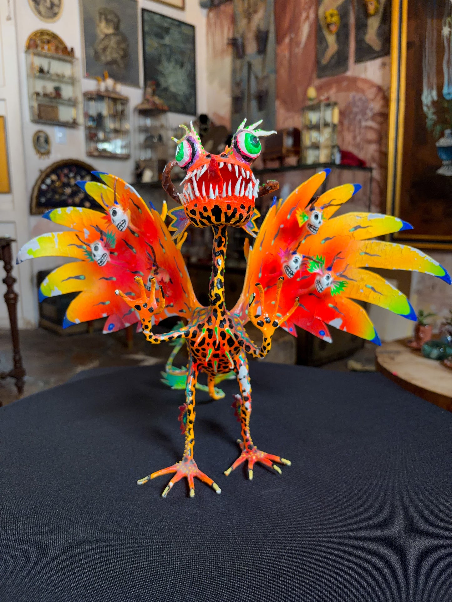 Handcrafted papier-mache alebrije dragon sculpture with skulls figure, Oaxacan Mexican folk art