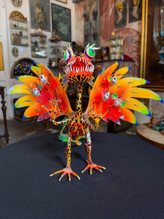 Handcrafted papier-mache alebrije dragon sculpture with skulls figure, Oaxacan Mexican folk art