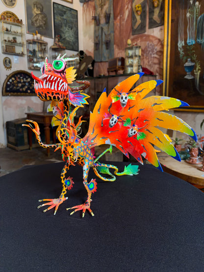 Handcrafted papier-mache alebrije dragon sculpture with skulls figure, Oaxacan Mexican folk art, side view