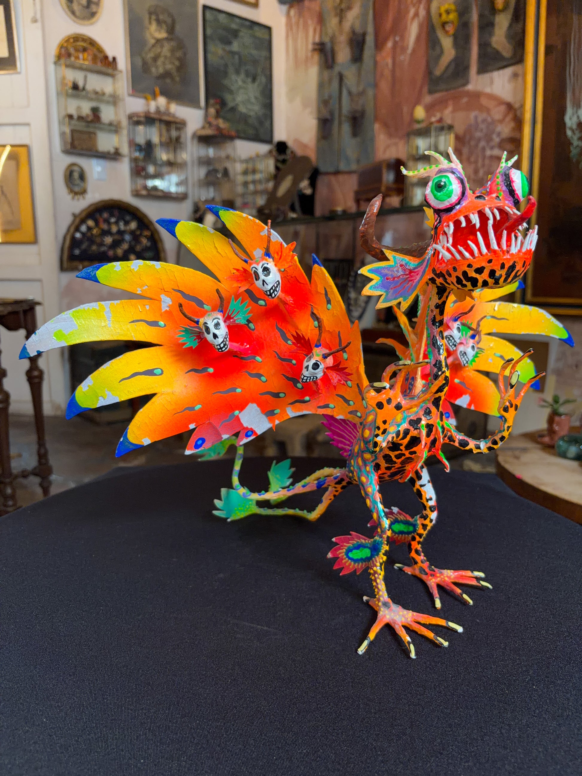 Handcrafted papier-mache alebrije dragon sculpture with skulls figure, Oaxacan Mexican folk art, back view