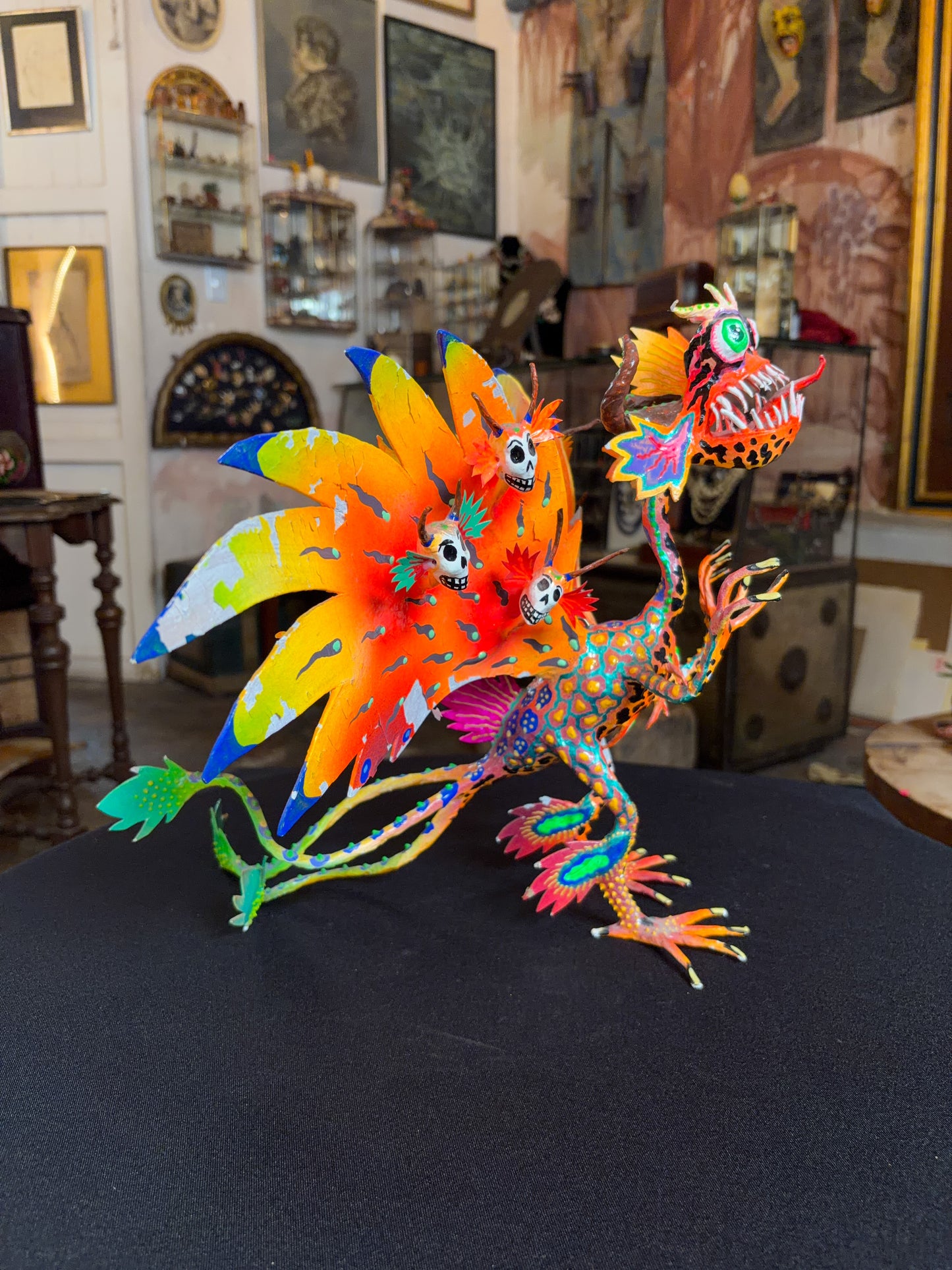 Handcrafted papier-mache alebrije dragon sculpture with skulls figure, Oaxacan Mexican folk art, painted detail, wing