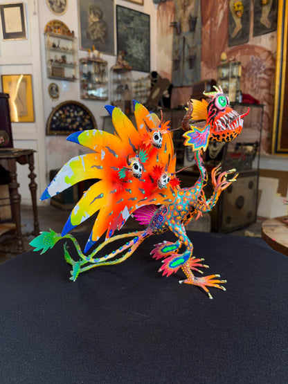 Handcrafted papier-mache alebrije dragon sculpture with skulls figure, Oaxacan Mexican folk art, painted detail, wing