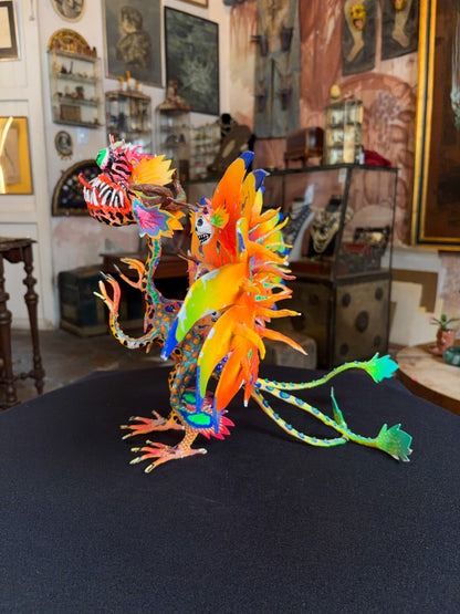 Handcrafted papier-mache alebrije dragon sculpture with skulls figure, Oaxacan Mexican folk art, painted detail, skull motif