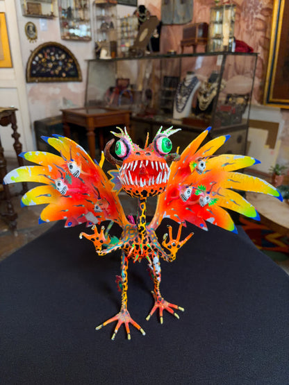 Handcrafted papier-mache alebrije dragon sculpture with skulls figure, Oaxacan Mexican folk art, painted detail, scales