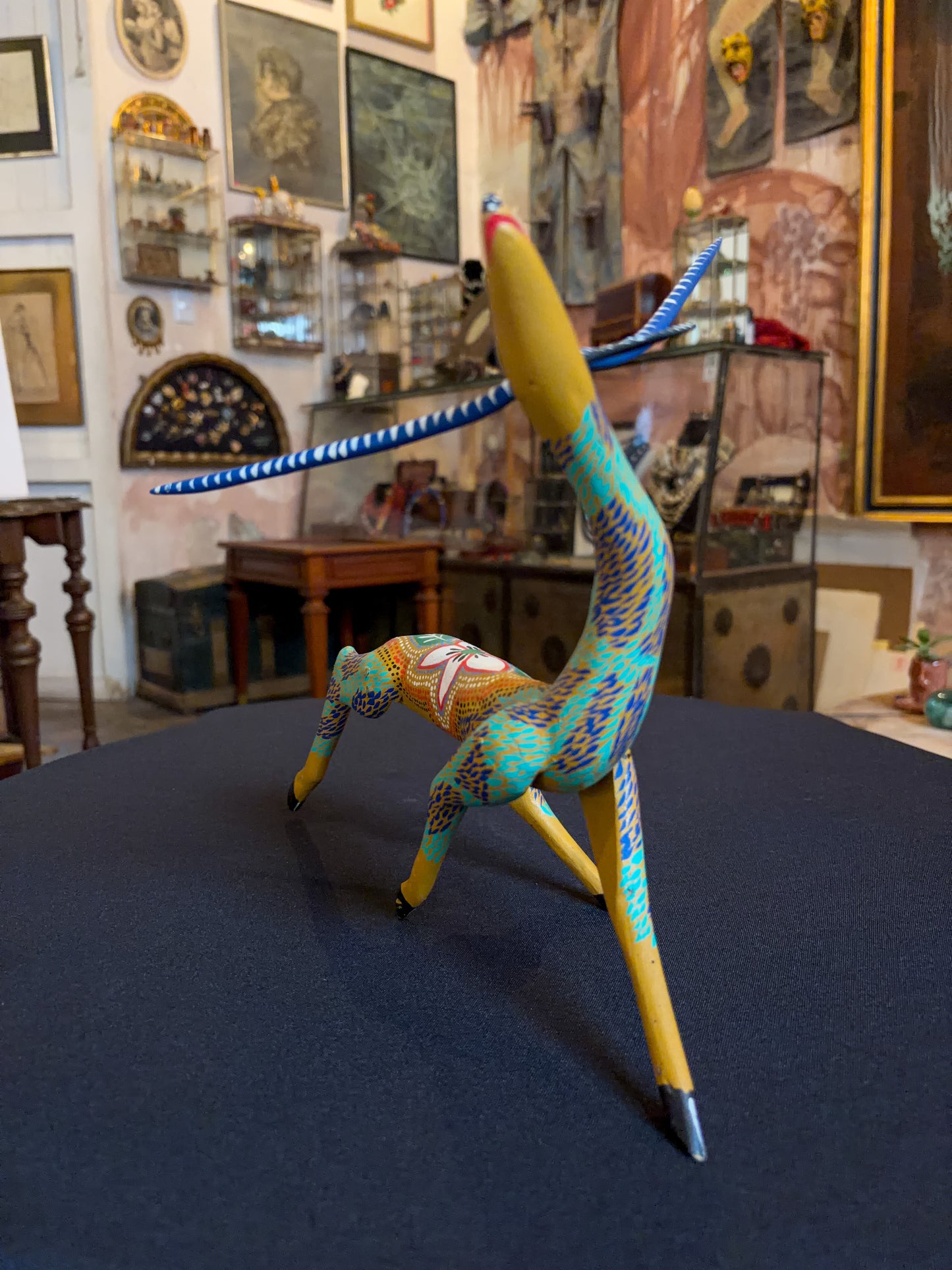 Handcrafted polychrome copal wood Oaxacan deer figure alebrije, Mexican folk art, three-quarter front, arched neck and painted body