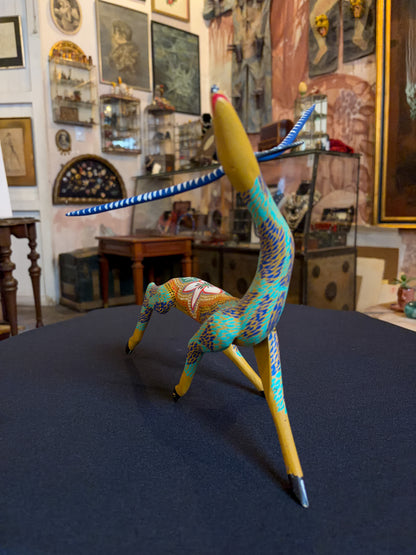 Handcrafted polychrome copal wood Oaxacan deer figure alebrije, Mexican folk art, three-quarter front, arched neck and painted body