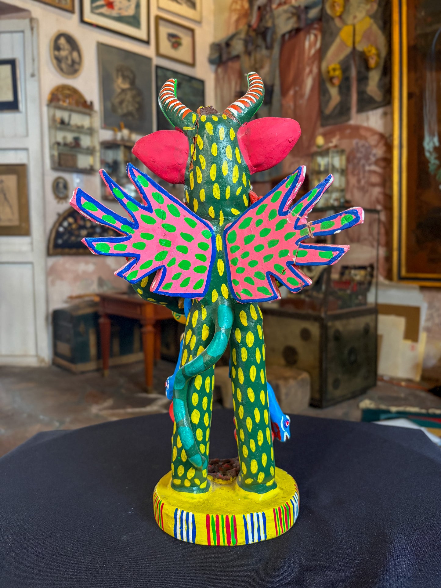 Polychrome fired clay devil figurine with lizard alebrije, Michoacán Mexican folk art, back view, spread wings and lizard