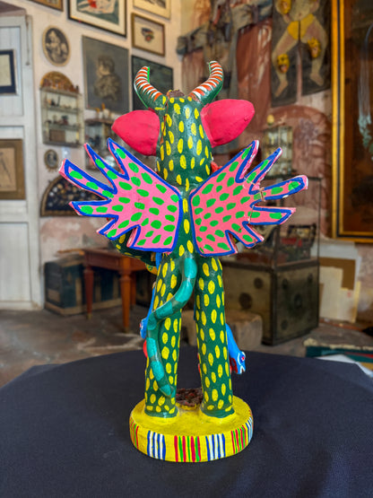 Polychrome fired clay devil figurine with lizard alebrije, Michoacán Mexican folk art, back view, spread wings and lizard