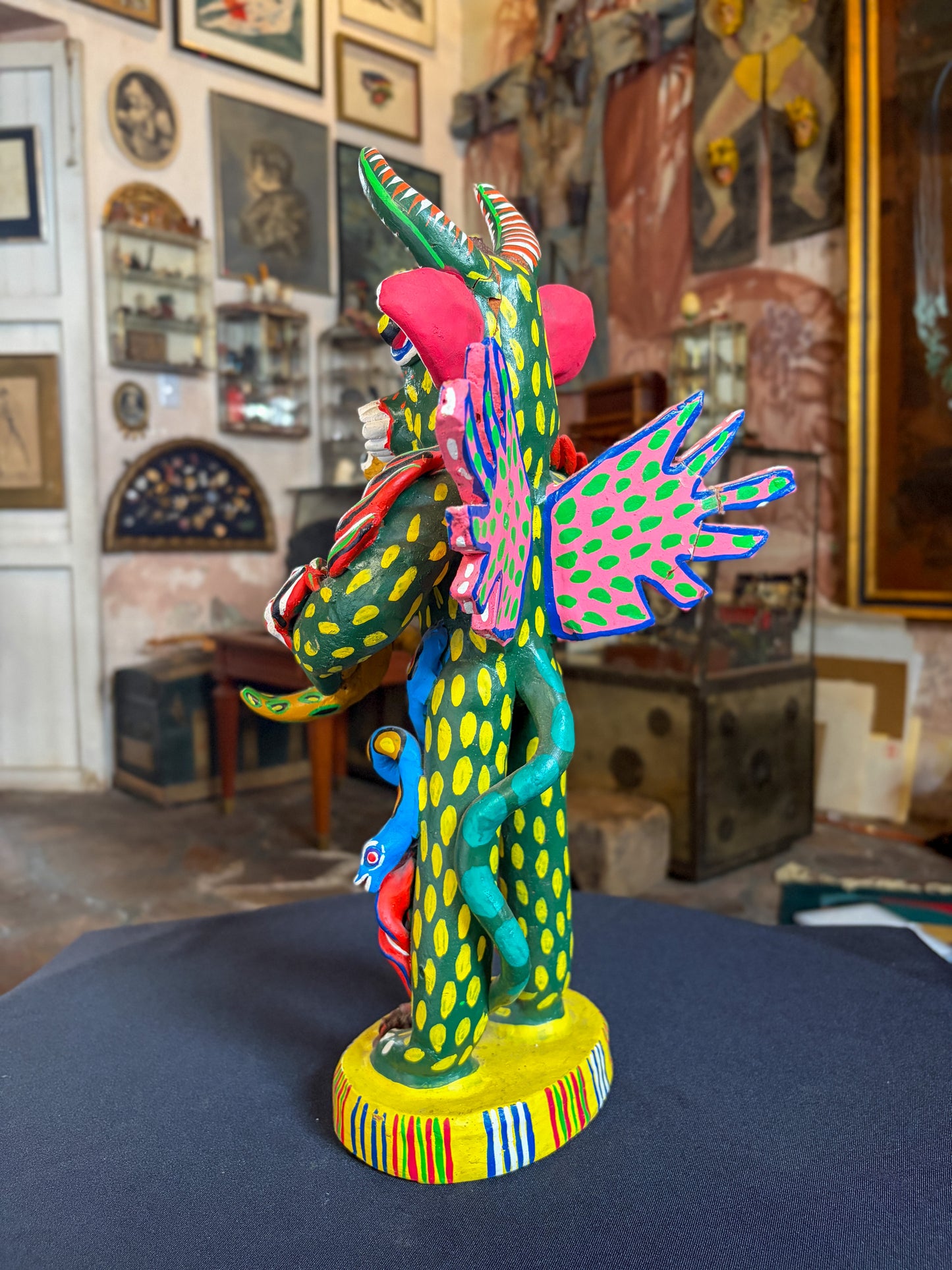 Polychrome fired clay devil figurine with lizard alebrije, Michoacán Mexican folk art, side profile, lizard climbing body