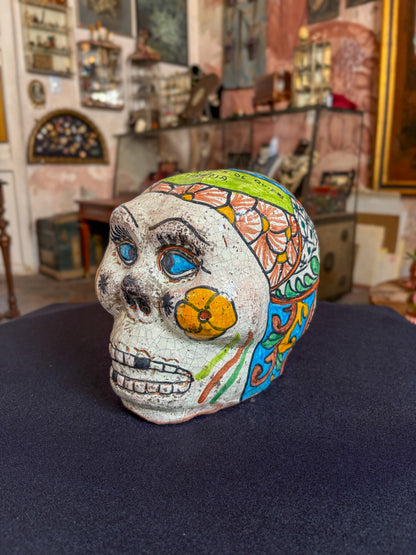 Handcrafted glazed clay skull ornament, Puebla Mexican folk art, side view