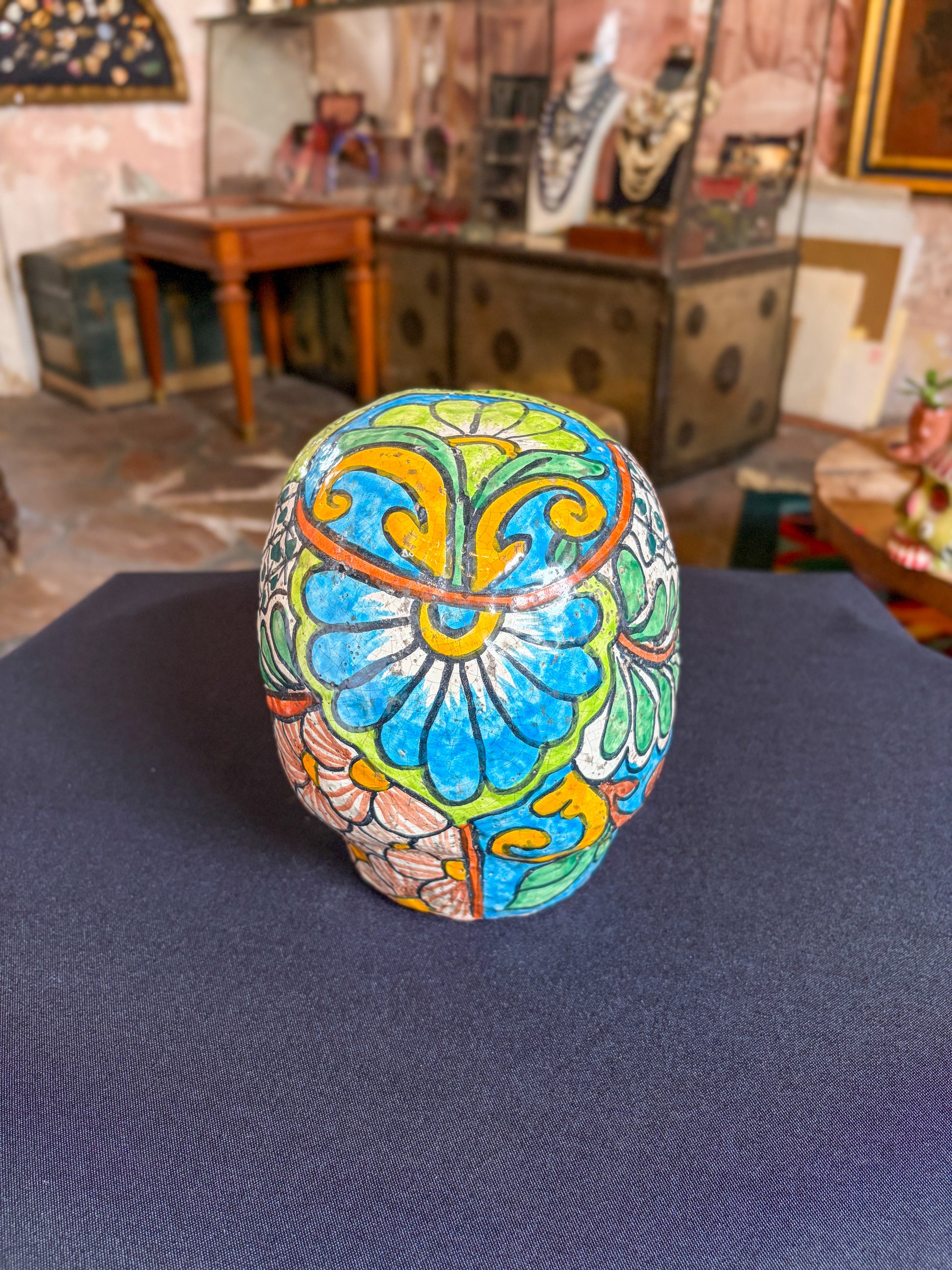 Handcrafted glazed clay skull ornament, Puebla Mexican folk art, back view, blue floral mandala pattern
