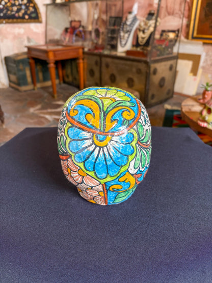 Handcrafted glazed clay skull ornament, Puebla Mexican folk art, back view, blue floral mandala pattern