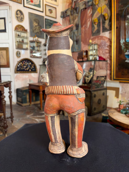 Hand-modeled fired clay hunter figurine with mineral pigments, San Agustin Oapan Guerrero Mexico, circa 1980s, back view, striped pants detail