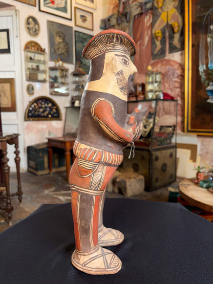 Hand-modeled fired clay hunter figurine with mineral pigments, San Agustin Oapan Guerrero Mexico, circa 1980s, side profile, sombrero and pistol