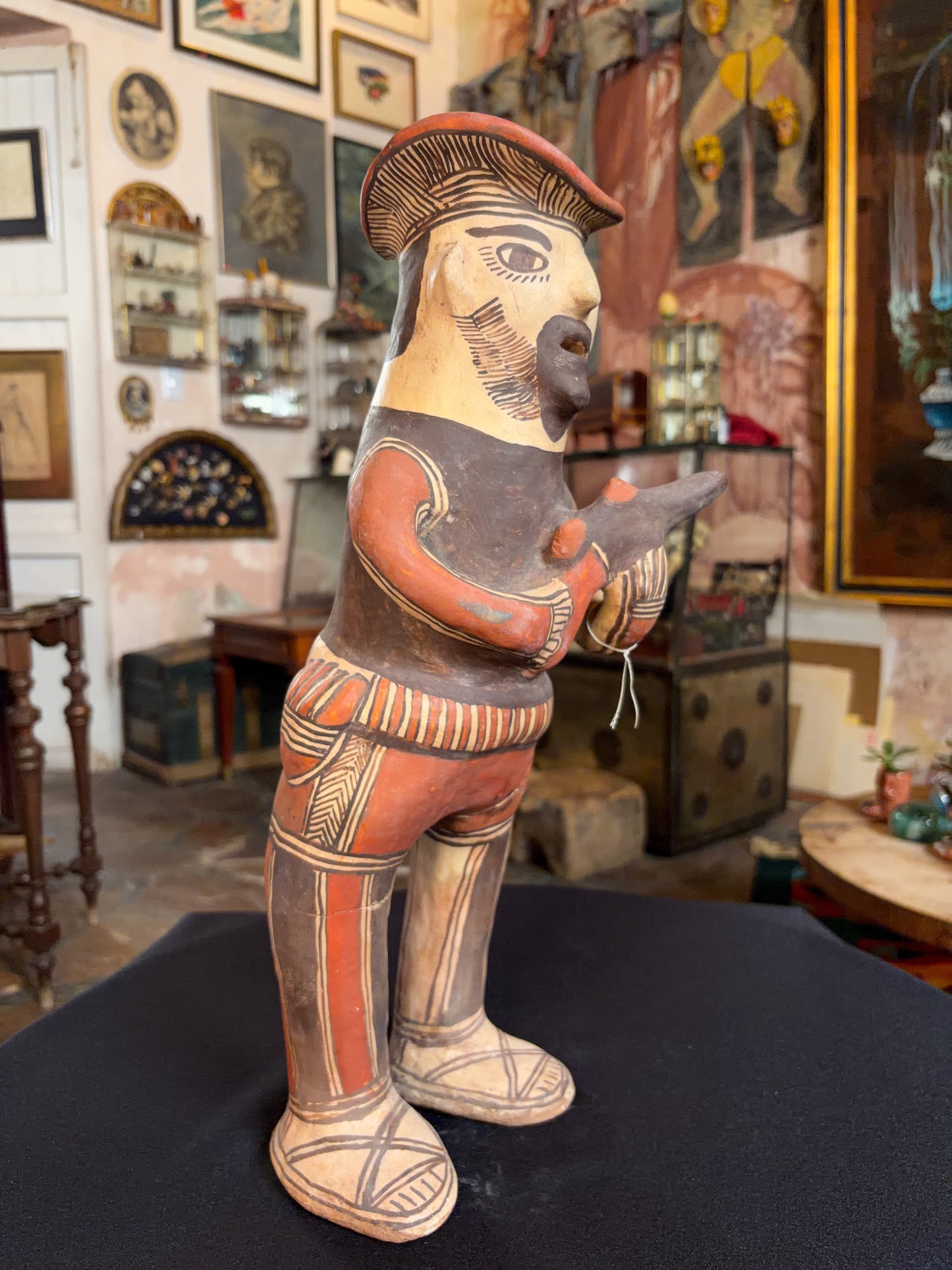 Hand-modeled fired clay hunter figurine with mineral pigments, San Agustin Oapan Guerrero Mexico, circa 1980s, right side profile, pistol raised