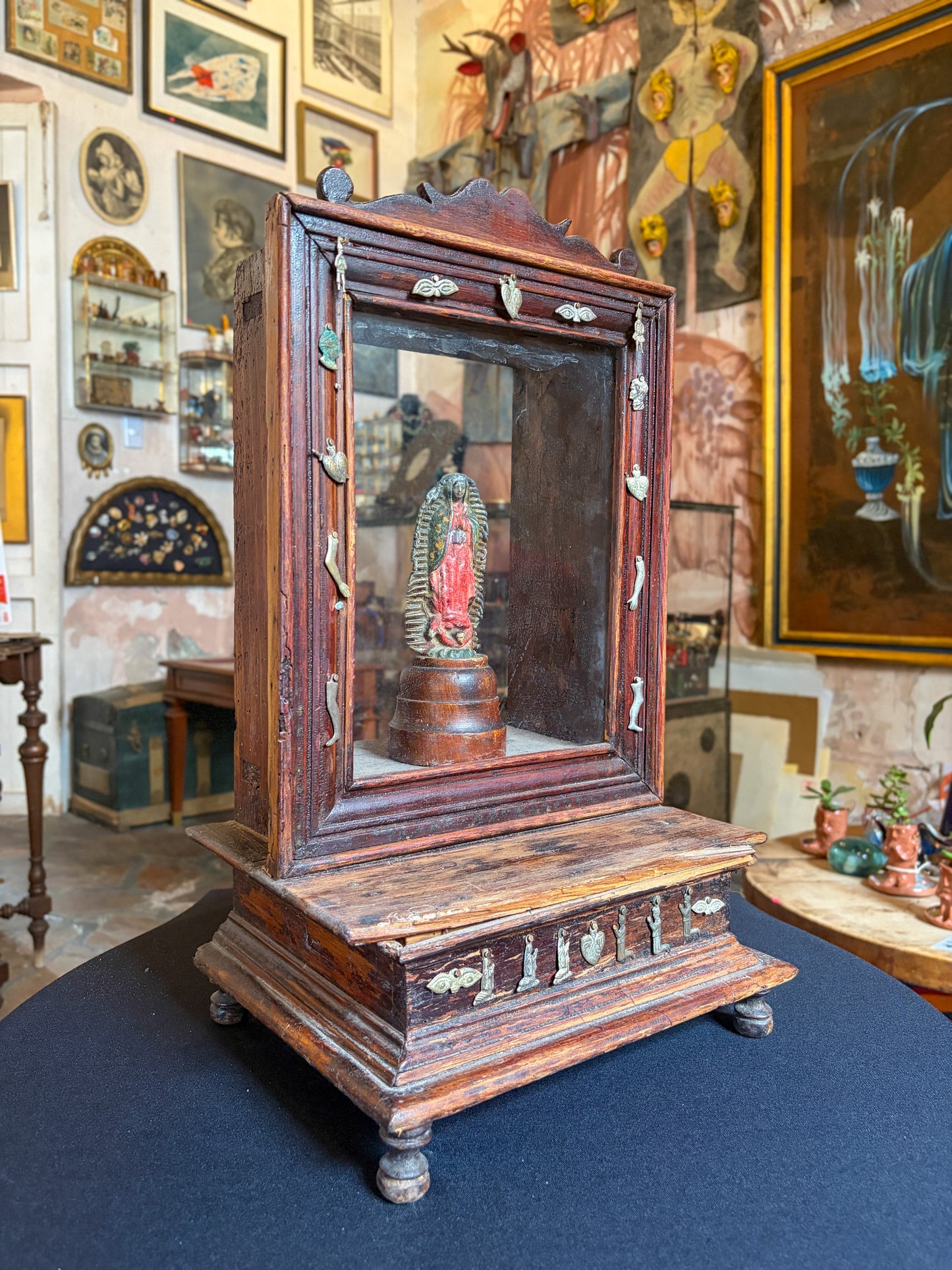 Handcrafted wood niche with metal milagros and glass inlays, Mexican folk art, side view