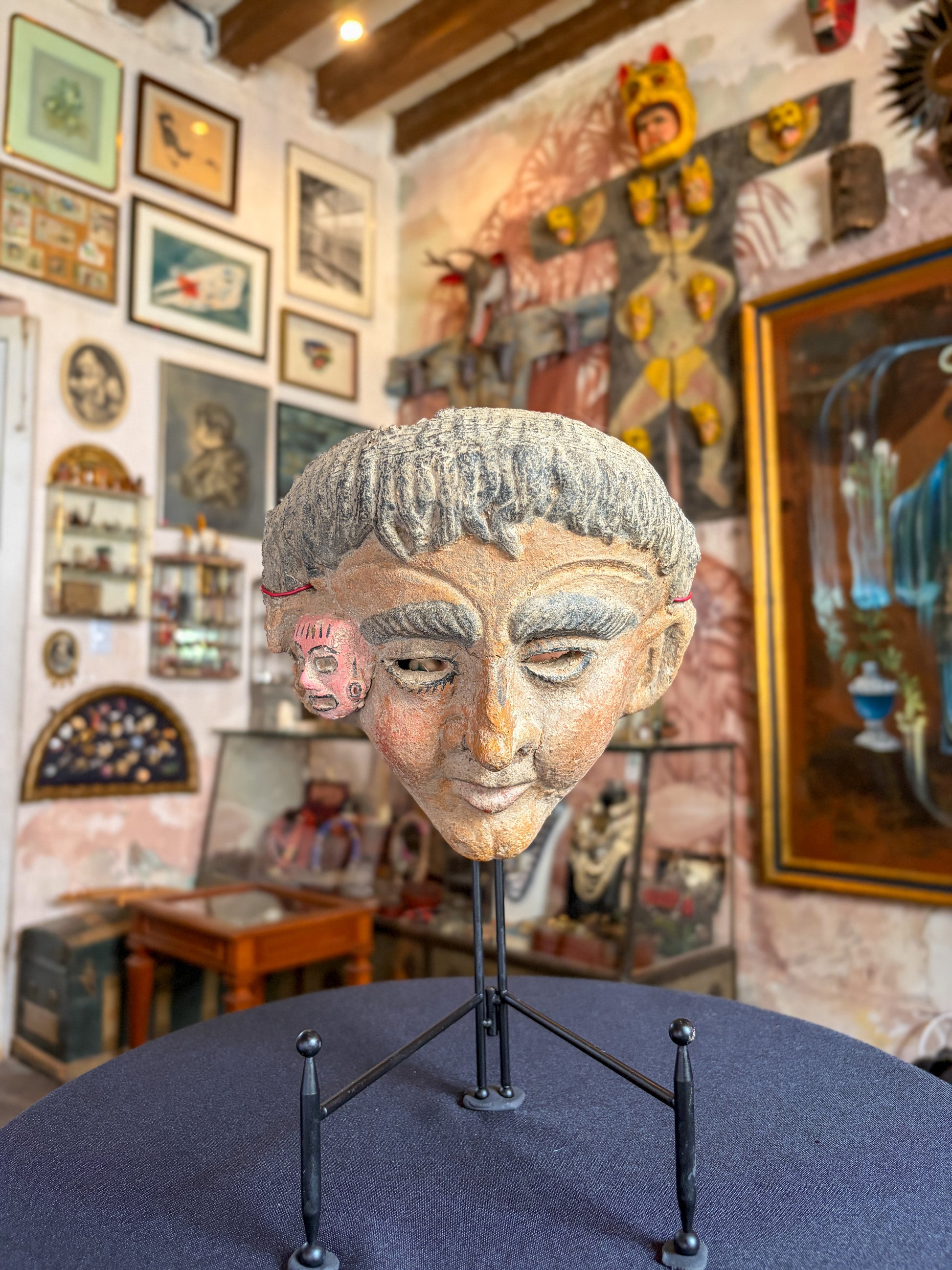 Modeled clay mestizo face miniature mask with pre-Hispanic effigy, Mexican folk art, side view