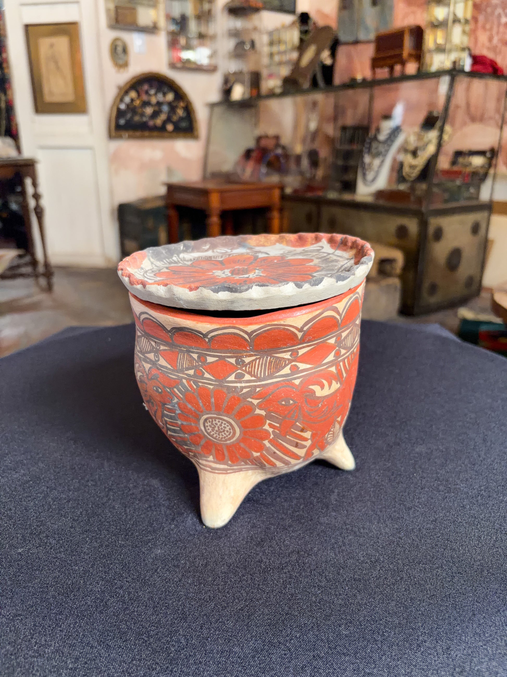 Handcrafted baked clay three-legged vessel with freehand mineral slip decoration, Oaxaca, Guerrero Mexican folk, side view