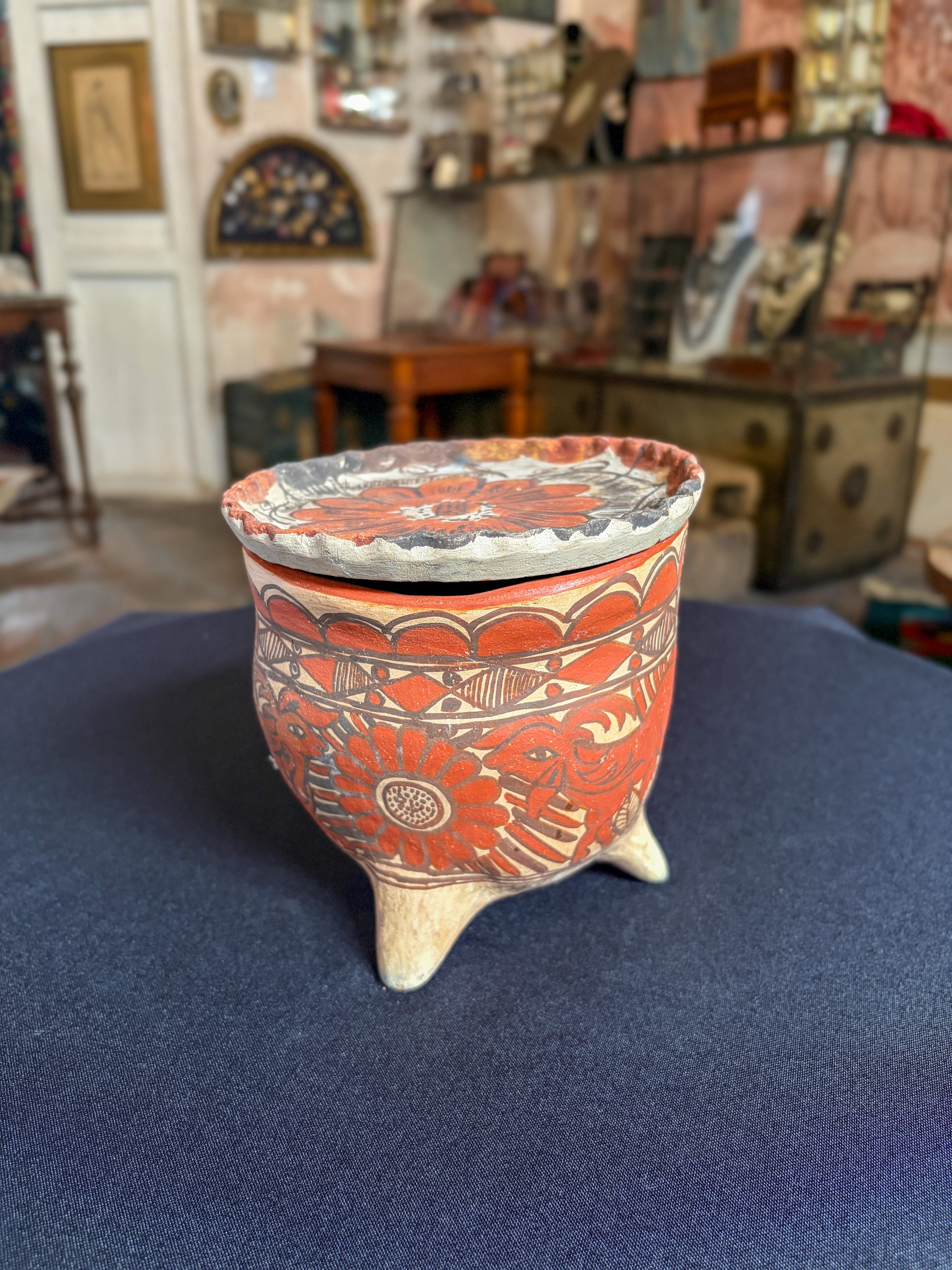 Handcrafted baked clay three-legged vessel with freehand mineral slip decoration, Oaxaca, Guerrero Mexican folk art, top view