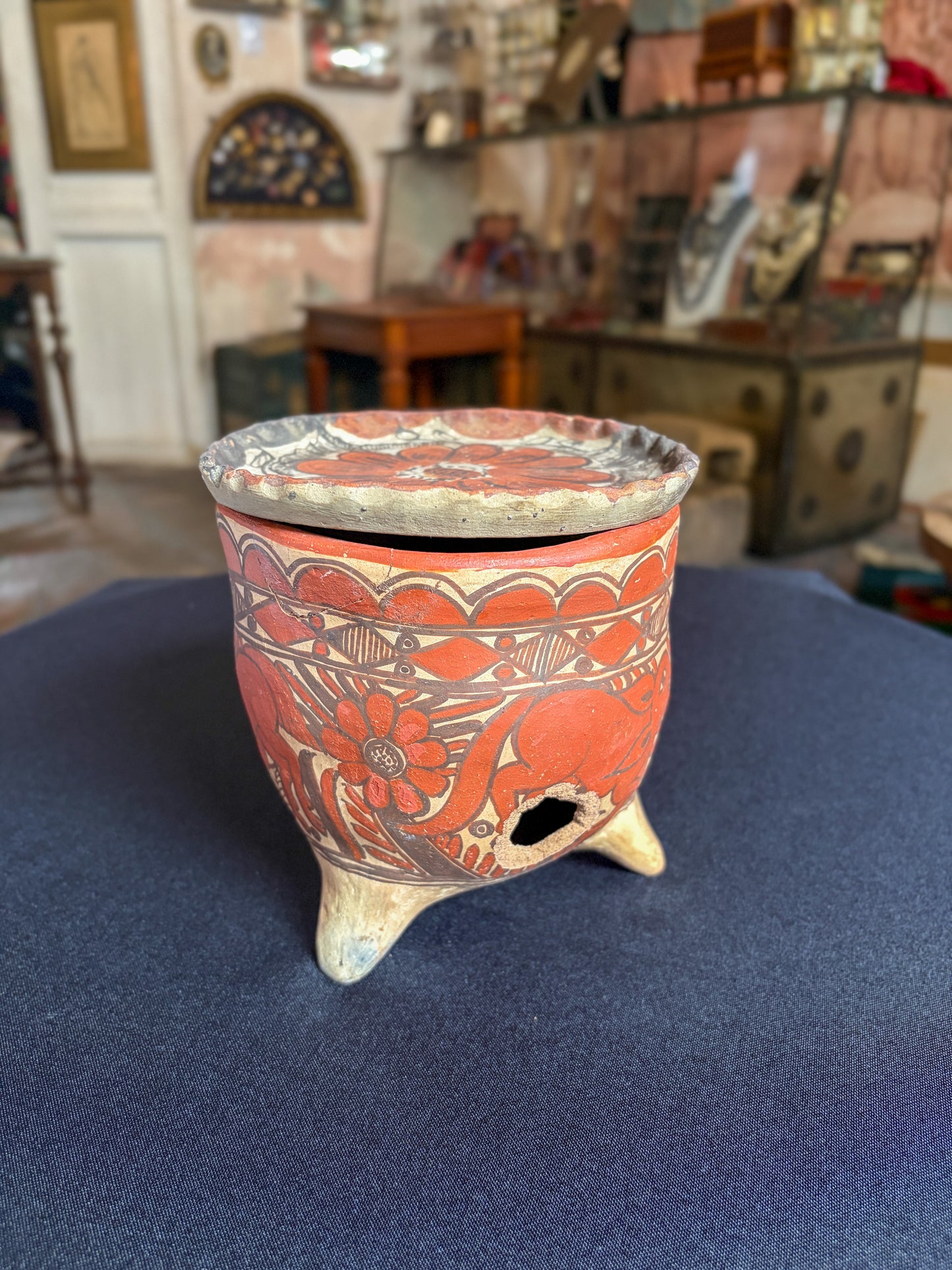 Handcrafted baked clay three-legged vessel with freehand mineral slip decoration, Oaxaca, Guerrero Mexican folk, carved floral body, tripod legs