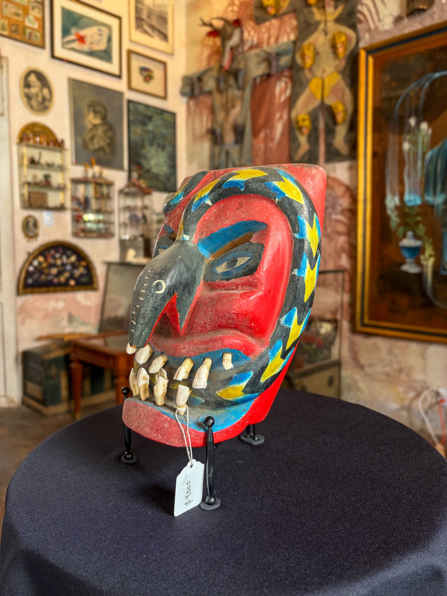Handcrafted wood devil dance mask with real animal teeth and carved serpent, by maestro Victoriano Salgado, side view