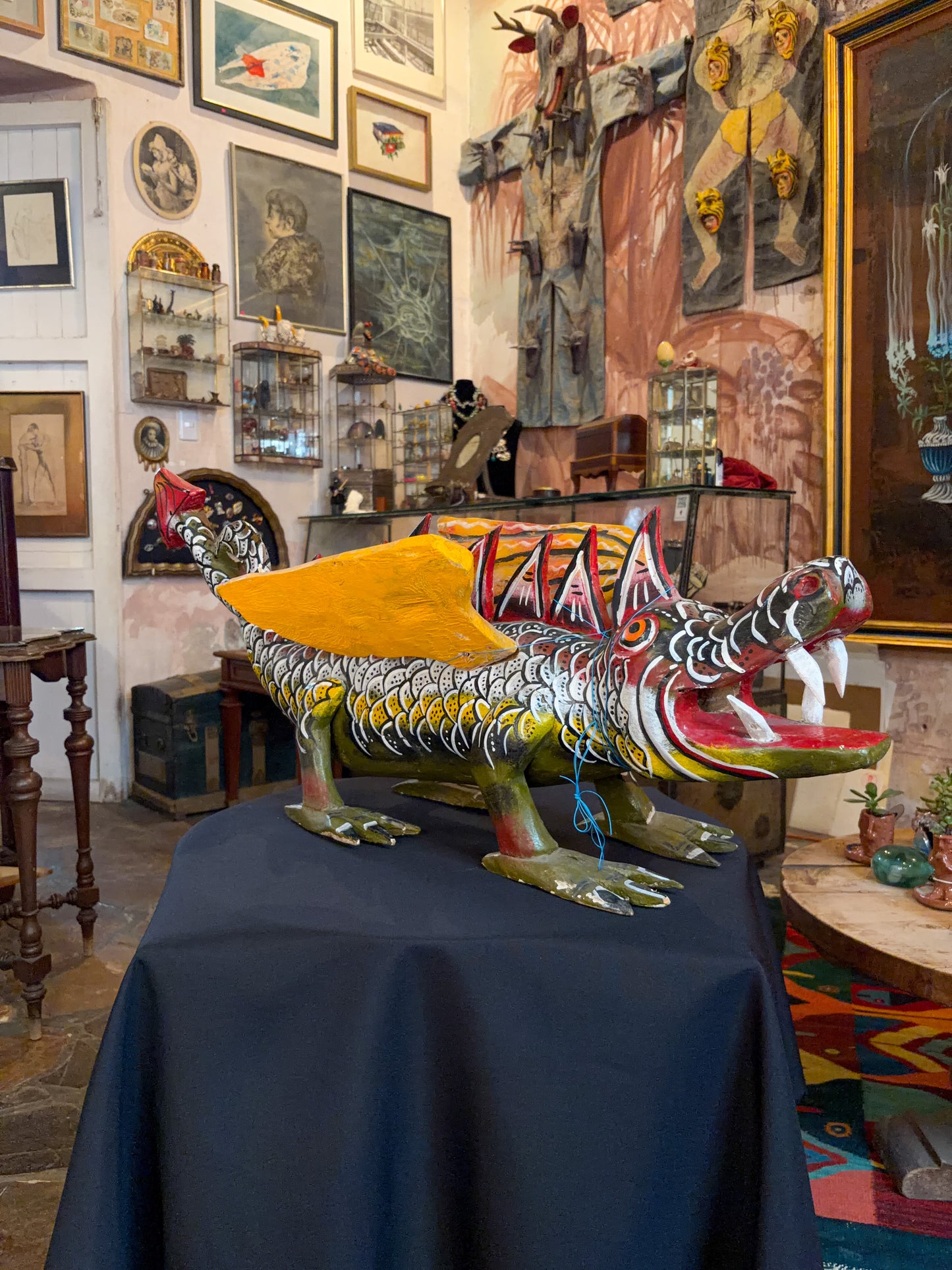 Polychrome carved wood winged dragon sculpture alebrije, Guerrero Mexican folk art, in-situ display, head and open mouth, studio setting