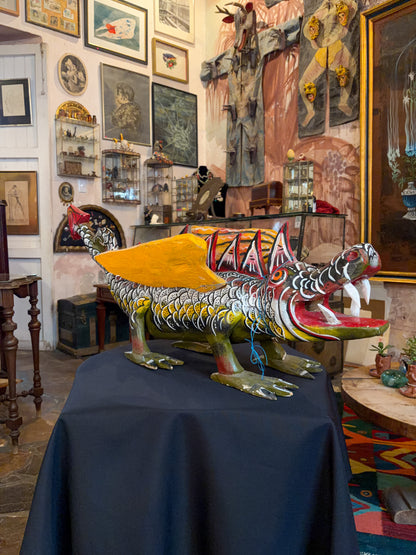 Polychrome carved wood winged dragon sculpture alebrije, Guerrero Mexican folk art, in-situ display, head and open mouth, studio setting